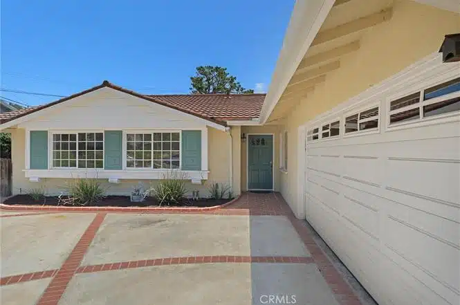 Single-story house with blue door and a red-tiled roof in California.