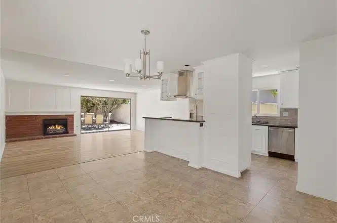 Living space with kitchen, and a chandelier in California.