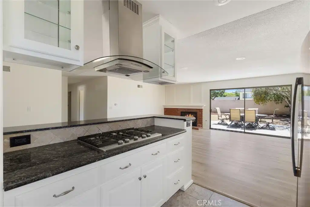 Kitchen with a black granite countertop and stainless steel stove in California.