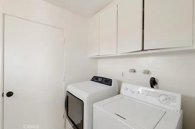 laundry room with a whitewashing machine and dryer in California.