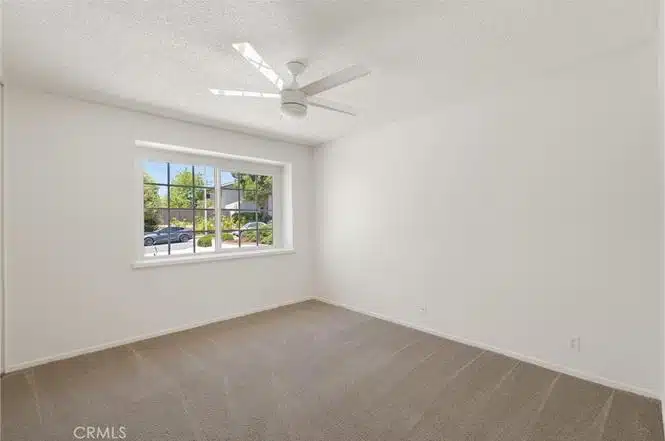 empty room with white walls and carpet and ceiling fan in California.
