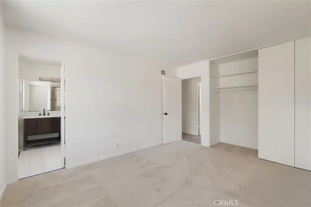 Empty bedroom with closet with shelves in California