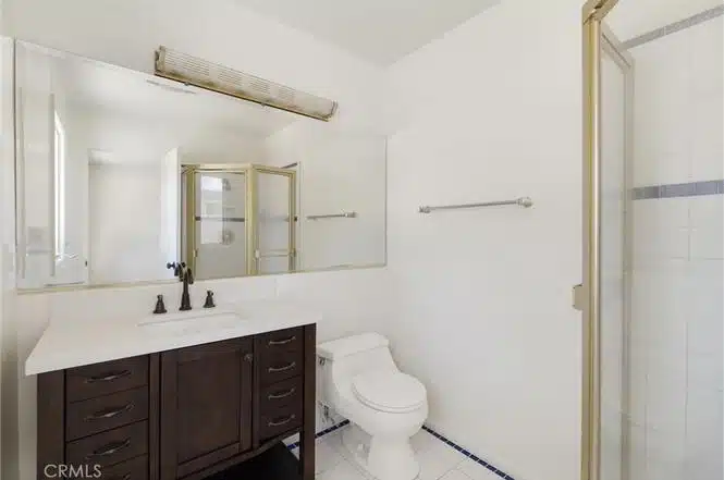bathroom with a dark wood vanity and white countertop in California.