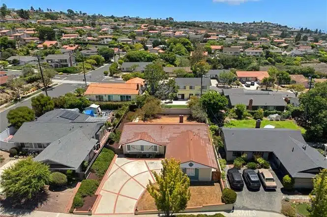 Aerial view of a neighborhood with red-roofed houses in California.