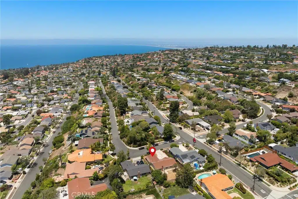 Aerial view of a coastal neighborhood with rows of houses in California.