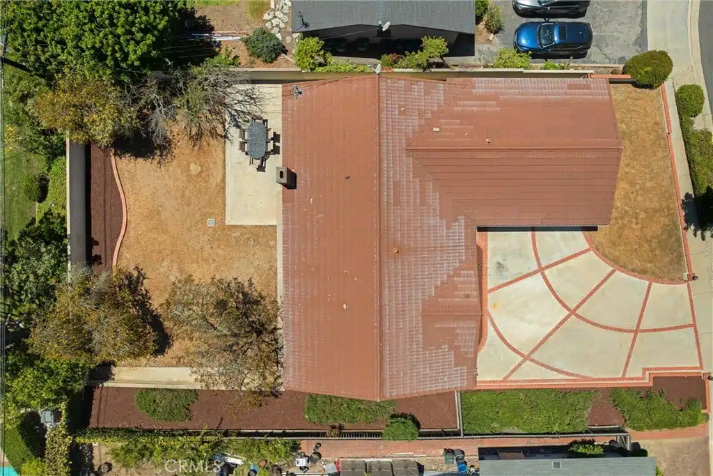 Aerial view of a red-roofed house with a circular driveway in California