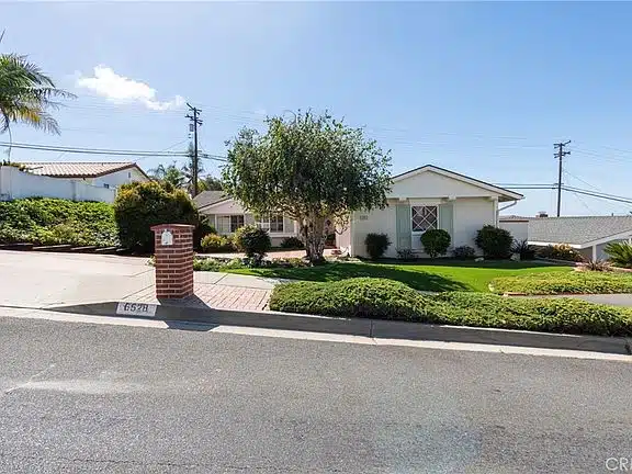 home with large tree, and brick mailbox in California.