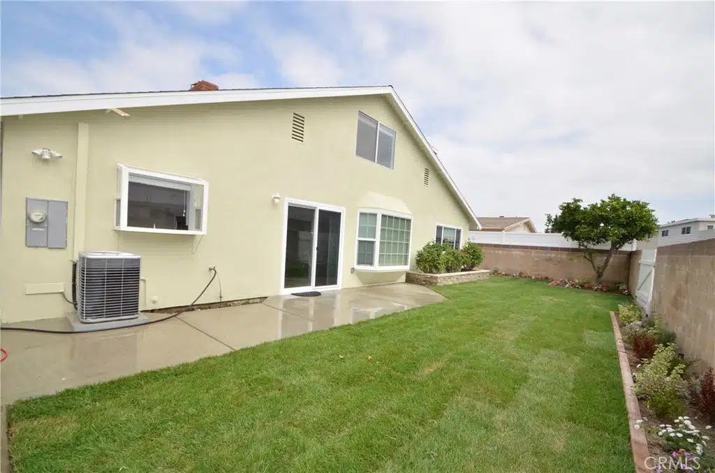 Single-story house with large windows, and a sliding glass door in California.