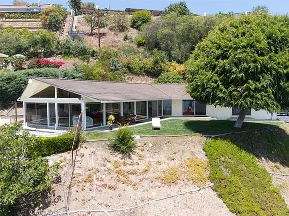 Luxury home with large glass windows and slanted roof in California.
